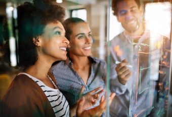 Programmers cooperating working at information technology company